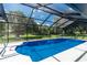 The screened-in pool with stairs and a metal handrail at 234 Antofagasta St, Punta Gorda, FL 33983