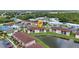 Aerial view of condo community featuring a scenic pond and convenient parking spaces at 25100 Sandhill Blvd # V202, Punta Gorda, FL 33983