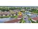 Aerial view of a condo community featuring pond, pool, tennis court, and convenient parking at 25100 Sandhill Blvd # V202, Punta Gorda, FL 33983