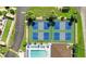 A view of the tennis courts surrounded by mature landscaping and a glimpse of the community pool at 25100 Sandhill Blvd # V202, Punta Gorda, FL 33983