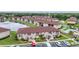 Beautiful aerial view of condos with lush landscaping and a serene pond in the Deep Creek Gardens community at 25100 Sandhill Blvd # V202, Punta Gorda, FL 33983