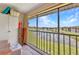 Spacious balcony with seating overlooking the lake and community amenities at 25100 Sandhill Blvd # V202, Punta Gorda, FL 33983