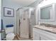 Bright bathroom featuring step-in shower, granite countertop, and square mirror at 25100 Sandhill Blvd # V202, Punta Gorda, FL 33983