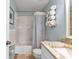 Bathroom featuring a shower-tub combo, granite countertop, and handy towel rack at 25100 Sandhill Blvd # V202, Punta Gorda, FL 33983