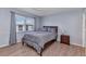 Comfortable bedroom with wood-look floors, neutral paint, and natural light at 25100 Sandhill Blvd # V202, Punta Gorda, FL 33983
