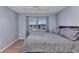 Bedroom featuring wood-look flooring, neutral paint, and ample natural light at 25100 Sandhill Blvd # V202, Punta Gorda, FL 33983