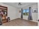 Bright bedroom with wood-look tile, ceiling fan, and large window with lovely view at 25100 Sandhill Blvd # V202, Punta Gorda, FL 33983