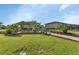 Outdoor seating in a landscaped common area with lush tropical plants and mature trees at 25100 Sandhill Blvd # V202, Punta Gorda, FL 33983