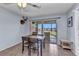 Cozy dining area with table, chairs and sliding glass door that leads to the balcony at 25100 Sandhill Blvd # V202, Punta Gorda, FL 33983