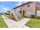 Exterior of the residence shows well-maintained lawn and sidewalk leading to the entrance of the building at 25100 Sandhill Blvd # V202, Punta Gorda, FL 33983