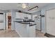 Cozy kitchen featuring sleek countertops, white cabinets, and stainless steel microwave at 25100 Sandhill Blvd # V202, Punta Gorda, FL 33983