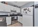Functional kitchen featuring white cabinetry, stainless steel appliances and tile flooring at 25100 Sandhill Blvd # V202, Punta Gorda, FL 33983