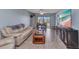 Bright living room with sliding doors, featuring tile flooring, and plenty of natural light at 25100 Sandhill Blvd # V202, Punta Gorda, FL 33983