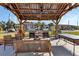 Outdoor grill area with stainless steel grills, seating, and lush landscaping, ideal for community gatherings and barbecues at 25100 Sandhill Blvd # V202, Punta Gorda, FL 33983