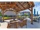 Inviting outdoor seating area under a wooden pergola, featuring comfortable benches and tables for relaxing and socializing at 25100 Sandhill Blvd # V202, Punta Gorda, FL 33983