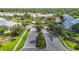A picturesque view of a gated community with lush landscaping, a pool, and well-maintained homes at 26548 Castleview Way, Wesley Chapel, FL 33544