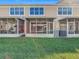 A view of the townhome backyards from the lawn at 26548 Castleview Way, Wesley Chapel, FL 33544