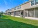 A view of the townhome backyards from the lawn at 26548 Castleview Way, Wesley Chapel, FL 33544