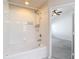 Bathroom boasts a soaking tub with a shower head and white tiled walls at 26548 Castleview Way, Wesley Chapel, FL 33544