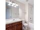 This bathroom features tile flooring, wooden cabinets, and a shower-tub combo at 26548 Castleview Way, Wesley Chapel, FL 33544
