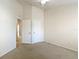 Carpeted bedroom with multiple closet doors at 26548 Castleview Way, Wesley Chapel, FL 33544