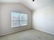 This cozy carpeted bedroom has a high ceiling and a large window that lets in plenty of natural light at 26548 Castleview Way, Wesley Chapel, FL 33544