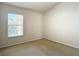 Carpeted bedroom featuring a window with views of neighborhood at 26548 Castleview Way, Wesley Chapel, FL 33544