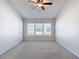 Bright bedroom features a ceiling fan and a large window for ample natural light at 26548 Castleview Way, Wesley Chapel, FL 33544