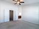 Bedroom with neutral carpeting, walk-in closets, and a full ensuite bathroom at 26548 Castleview Way, Wesley Chapel, FL 33544