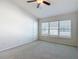 Spacious bedroom with a ceiling fan, neutral carpeting, and a bright window at 26548 Castleview Way, Wesley Chapel, FL 33544