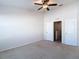 Carpeted bedroom with a ceiling fan and a closet for storage at 26548 Castleview Way, Wesley Chapel, FL 33544