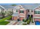 Multi-story townhome featuring an attached garage and neatly trimmed landscaping at 26548 Castleview Way, Wesley Chapel, FL 33544