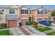Charming townhome with a two-car garage, brick-paver driveway, and well-maintained landscaping at 26548 Castleview Way, Wesley Chapel, FL 33544