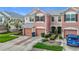 Multi-story townhome featuring an attached garage and neatly trimmed landscaping at 26548 Castleview Way, Wesley Chapel, FL 33544