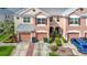 Beautiful multi-story townhome featuring a private two-car garage and manicured landscaping at 26548 Castleview Way, Wesley Chapel, FL 33544