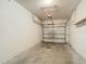 This empty garage has a concrete floor and white walls at 26548 Castleview Way, Wesley Chapel, FL 33544