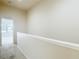 Hallway featuring carpet and neutral walls with a view of a bedroom with a window at 26548 Castleview Way, Wesley Chapel, FL 33544