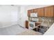Well-equipped kitchen featuring wooden cabinetry, granite countertops, and a stainless steel sink at 26548 Castleview Way, Wesley Chapel, FL 33544