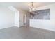 Open-concept living area showcasing a chandelier, tile flooring, and a half-wall separating the kitchen at 26548 Castleview Way, Wesley Chapel, FL 33544