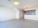 The open concept living room has tile floors and is adjacent to the kitchen and dining area at 26548 Castleview Way, Wesley Chapel, FL 33544
