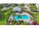 Community pool with a gazebo, plenty of seating and lush, tropical landscaping at 26548 Castleview Way, Wesley Chapel, FL 33544