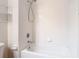 The tub-shower combo has tile walls, a shower head, and toiletry shelving at 26548 Castleview Way, Wesley Chapel, FL 33544
