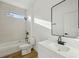 Modern bathroom features a shower-tub combo with black fixtures, and floating sink at 2813 Sally Ln, North Port, FL 34286