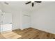 Bright bedroom featuring hardwood floors, white walls, and a closet at 2813 Sally Ln, North Port, FL 34286