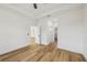 Bright bedroom featuring wood-look floors, a ceiling fan, and white walls at 2813 Sally Ln, North Port, FL 34286