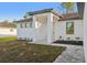 Inviting front entrance with modern lighting, neutral colors, and well maintained landscaping at 2813 Sally Ln, North Port, FL 34286