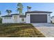 Beautiful one-story home with a two-car garage, manicured lawn, and neutral color palette at 2813 Sally Ln, North Port, FL 34286