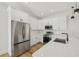 Modern kitchen with stainless steel appliances, white cabinets, and sleek countertops and fixtures at 2813 Sally Ln, North Port, FL 34286