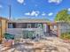 Backyard view with a mix of grass and concrete, featuring a white lattice fence, perfect for enjoying the outdoors at 2818 Olympic St, Sarasota, FL 34231