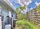 The backyard features water treatment hardware near a fenced yard and shed at 2818 Olympic St, Sarasota, FL 34231